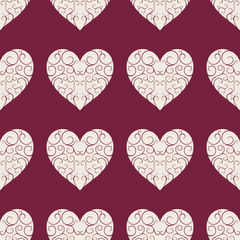Fototapeta na wymiar The pattern of the beautiful beige openwork hearts on a dark red