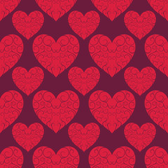Fototapeta na wymiar The pattern of the beautiful red openwork hearts on a dark backg