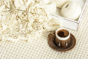 Obraz na płótnie Canvas crochet tablecloth, balls thread and coffee
