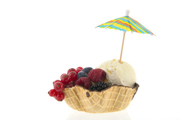 Cup vanilla ice with fruit and parasol