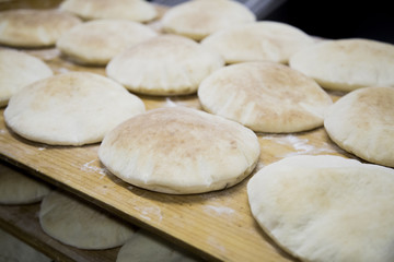 Fototapeta na wymiar Baking Syrian Bread on Oven