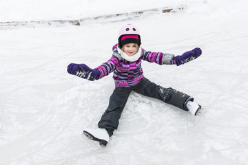Fototapeta na wymiar little girl enjoying ice skating in winter season