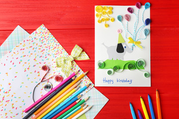 Handmade gift card on red wooden background