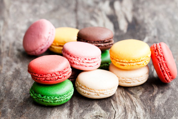 colorful  macarons on rustic wooden backrgound