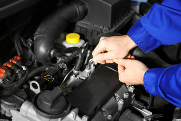 Mechanic repairing car with open hood