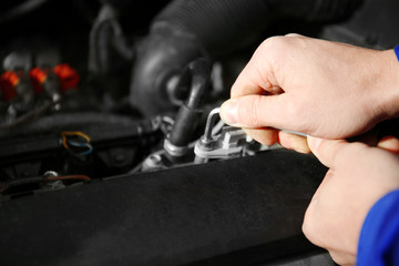 Mechanic repairing car with open hood
