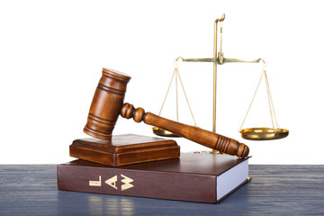 Judge gavel, scales and book on wooden table