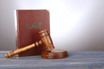 Judge gavel and book on wooden table