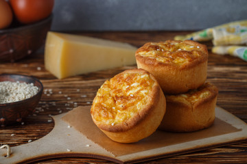 Mini pies with cheese, onion and egg. Tartlets. Delicious snack for gourmands. Selective focus
