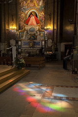 Old french church with light from stained glass 