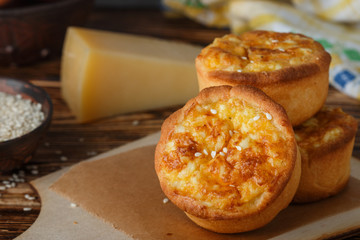 Mini pies with cheese, onion and egg. Tartlets. Delicious snack for gourmands. Selective focus
