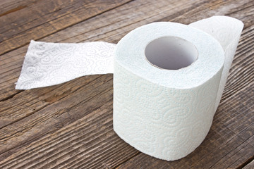 Toilet paper roll on wood background