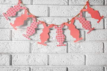 Easter garland on white brick wall background