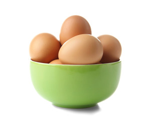 Raw eggs in bowl on white background