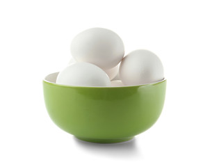 Raw eggs in bowl on white background