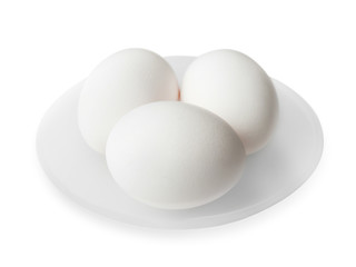 Raw eggs in plate on white background