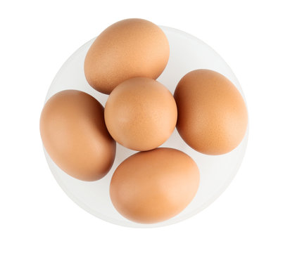 Raw eggs in plate on white background