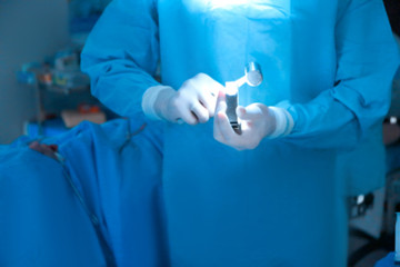 Surgeon with medical tools in operating room