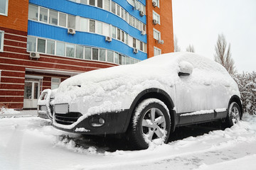 Car covered with snow on winter day