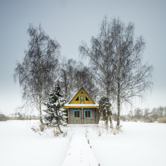 gray sky and single farmhouse in winter day