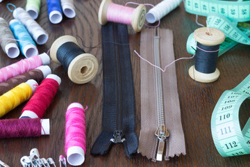 Colored thread, zippers and two centimeters on  table