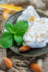 Fragrant nougat with almonds and candied orange.
