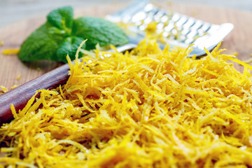 Zest of lemon and grater with wooden handle.