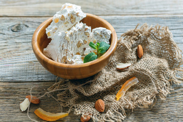 Wooden bowl with almond nougat.
