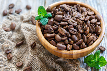 Roasted coffee beans in a bowl close up.