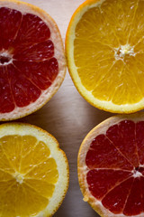 Fototapeta premium compositions of grey fruits, oranges and kiwis on a light blue and dark orange worn wooden backgrounds.