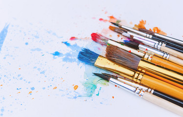 artistic brushes on wooden background