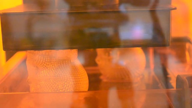 Timelapse 3d printer printing photopolymer. Print using special resins that harden due to laser exposure. 3D printer creates a transparent model of the skull