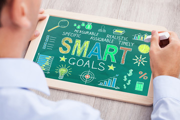 Businessperson Drawing Smart Goals Concept On Slate