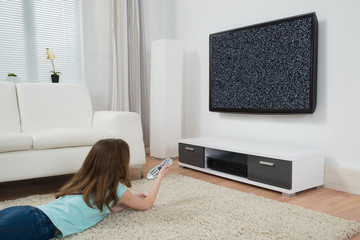 Girl With Remote Control Watching Television
