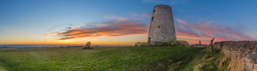 Fototapeta na wymiar Old Windmill at sunset