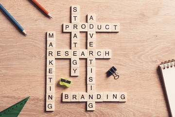 Conceptual business keywords on table with elements of game making crossword