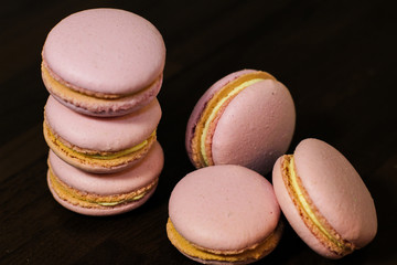 Freshly made pink french macarons on the tabke