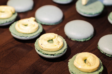 filling macarons with cream using piping bag