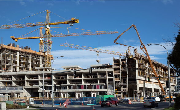 Construction of  three new high-rise building,  cranes, machine for pouring cement.