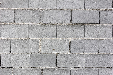 Gray concrete bricks laid in layers on top of each other - masonry