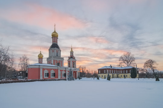 Old orthodox church on a cold winter evening at sunset. Trinity Church in Moscow in the manor Sviblovo