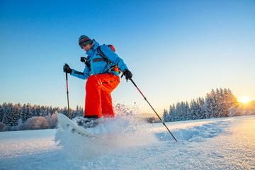 Snowshoe walker running in powder snow