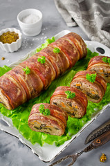 Oven baked meatloaf with bacon on a concrete grey background