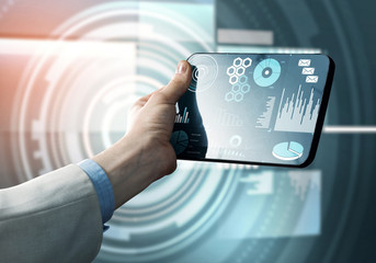 Media technology concept presented by businessman holding tablet with graphs and diagrams