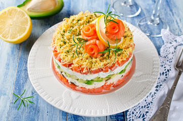 Layered salad with salmon, avocado and cream cheese