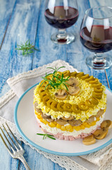 Layered salad with ham, mushrooms and corn