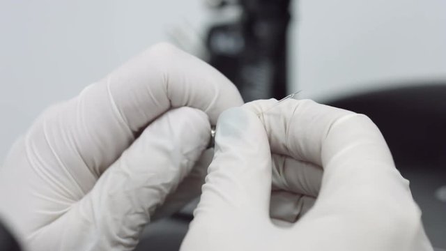 Insert ivf icsi pipette in holder, prepare needle for in vitro fertilization