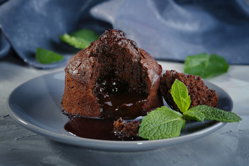 Chocolate fondant with mint on plate