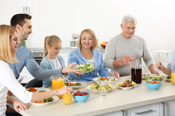 Happy family having lunch in kitchen