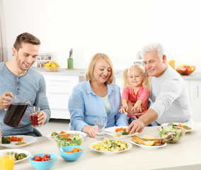 Happy family having lunch in kitchen